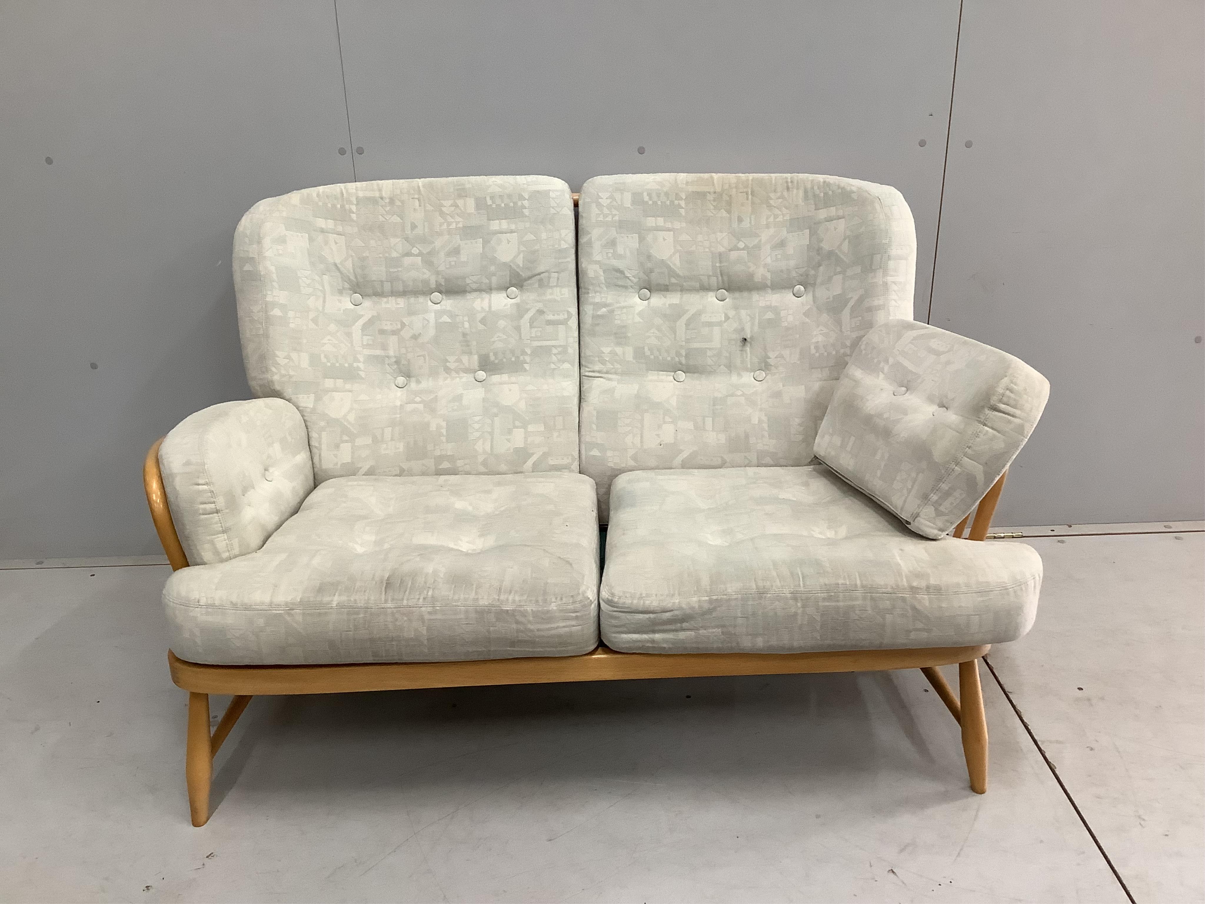 A pair of Ercol beech settees, width 140cm, depth 80cm, height 82cm